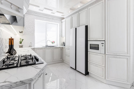 Modern interior with white kitchen and kitchen appliances in the country house.の写真素材