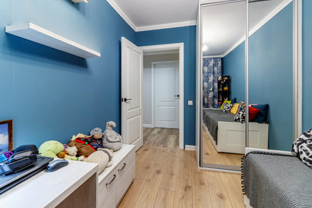 Corridor with white walls and doors in an apartment with a marble floor.の写真素材