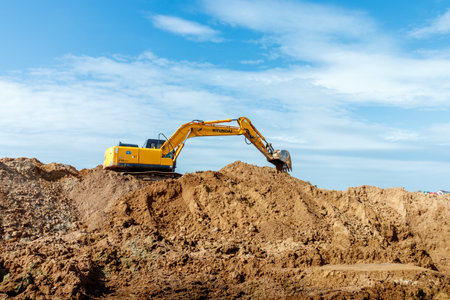 Excavator dig the trenches at a construction site. Trench for laying external sewer pipes. Sewage drainage system for a multi-story building. Digging the pit foundation.の写真素材
