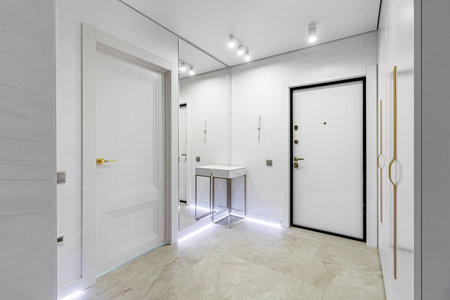 Modern entrance hall in light colors with interior doors in white and gold.の写真素材
