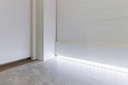 Fragment of classic interior with french herringbone parquet floor and skirting boards. The final stage of finishing works in the apartment.の写真素材