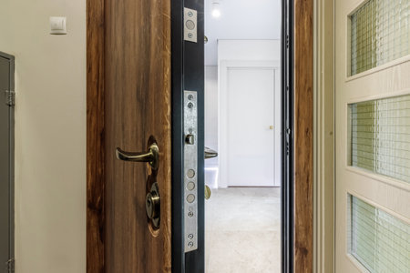 Entrance wooden door of natural color, in a multi-storey building. Entrance to the apartment.の写真素材