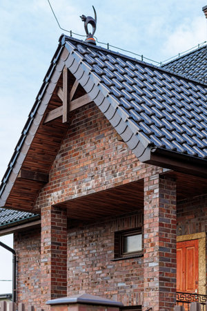 Fragment of a modern building lined with decorative bricks in the old style