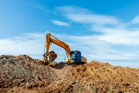 Excavator dig the trenches at a construction site. Trench for laying external sewer pipes. Sewage drainage system for a multi-story building. Digging the pit foundationの写真素材
