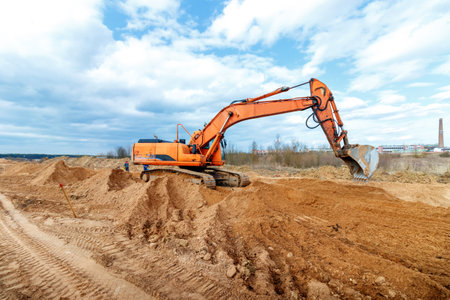 Excavator dig the trenches at a construction site. Trench for laying external sewer pipes. Sewage drainage system for a multi-story building. Digging the pit foundationの写真素材