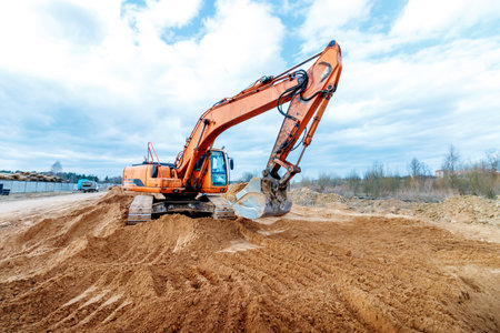 Excavator dig the trenches at a construction site. Trench for laying external sewer pipes. Sewage drainage system for a multi-story building. Digging the pit foundationの写真素材