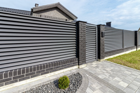 Fragment of a modern fence lined with decorative bricks in the old styleの写真素材