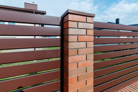 Fragment of a modern fence lined with decorative bricks in the old styleの写真素材