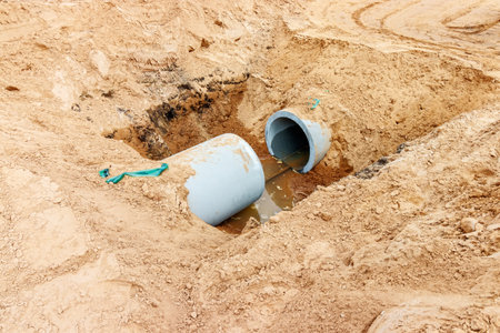 Concrete Drainage Pipe on a Construction Site .Concrete pipe stacked sewage water system aligned on site.の写真素材