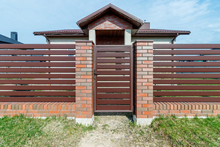 Fragment of a modern fence lined with decorative bricks in the old style.の写真素材