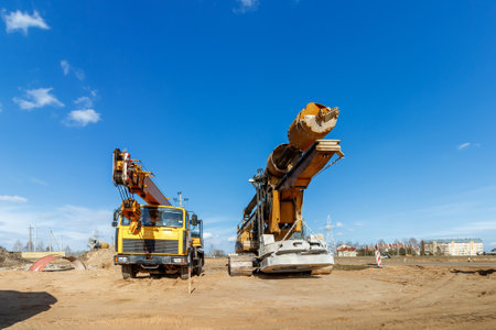 The construction site for the highway with heavy equipment. Two rotational exercises, lifting crane.の写真素材