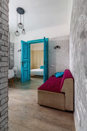 The interior of the apartment is in the old style, with high ceilings and an old wooden door of turquoise color.の写真素材