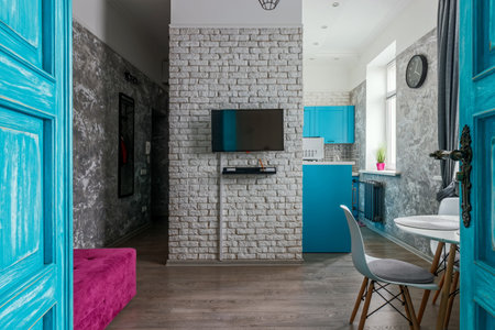 The interior of the apartment is in the old style, with high ceilings and an old wooden door of turquoise color.の写真素材