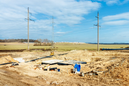Connecting a trench drain to a concrete manhole structure at construction site. Concrete pile in formwork frame for construct stormwater and underground utilities, pump stations, sewers pipes.の写真素材