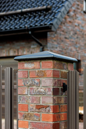 Fragment of a modern fence lined with decorative bricks in the old style.の写真素材