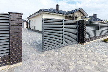 Fragment of a modern fence lined with decorative bricks in the old style.の写真素材