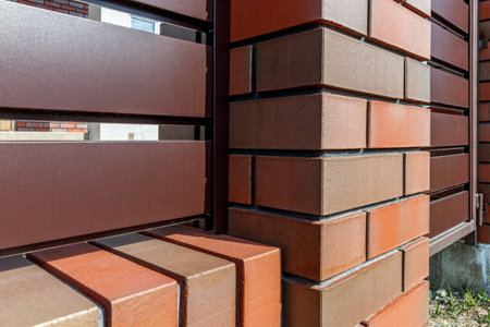 Fragment of a modern fence lined with decorative bricks in the old style.の写真素材