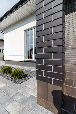 Fragment of a modern building lined with decorative bricks in the old style.の写真素材