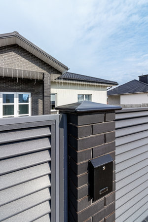 Fragment of a modern fence lined with decorative bricks in the old style.の写真素材