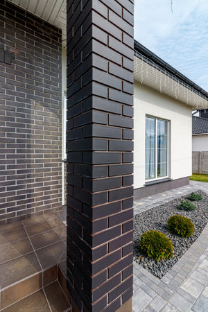 Fragment of a modern building lined with decorative bricks in the old style.の写真素材
