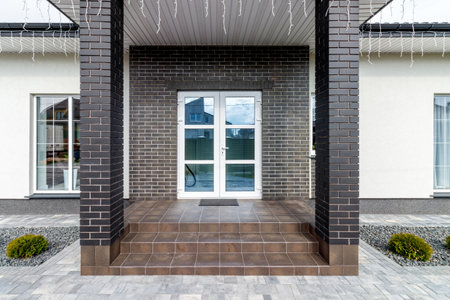 Fragment of a modern building lined with decorative bricks in the old style.の写真素材