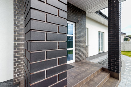 Fragment of a modern building lined with decorative bricks in the old style.の写真素材