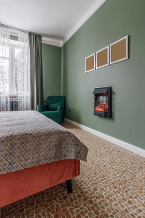 Bedroom in retro style with bed, old wardrobe and green walls.の写真素材