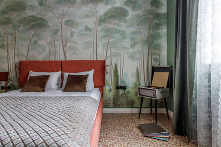 Bedroom in retro style with bed, old wardrobe and green walls.の写真素材