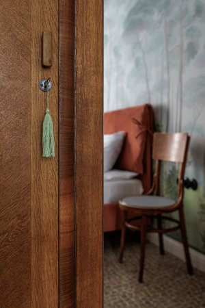 An old restored oak cabinet with a mirror in which an old oak chair is reflected.の写真素材