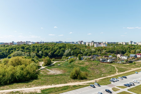 View of the city and the park area with the river from the window of a multi-storey building.の写真素材