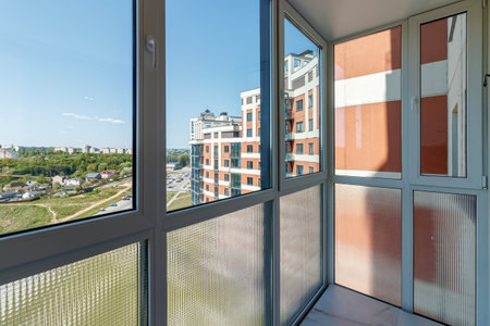 View through the huge balcony window to the park area and other houses.の写真素材