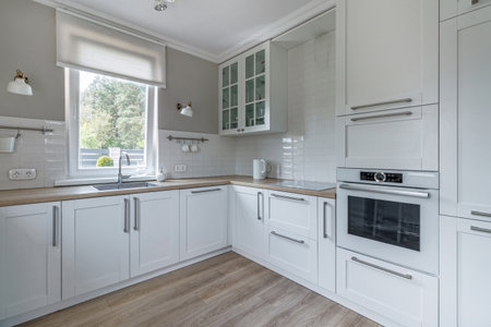 Stylish interior of a modern bright kitchen with a window, in a new house.の写真素材