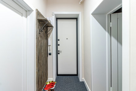Metal front door of white color, plain white a simple pattern.の写真素材