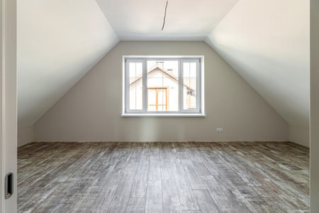 A room in a private house immediately after laying the floor, white unfinished walls and ceiling.