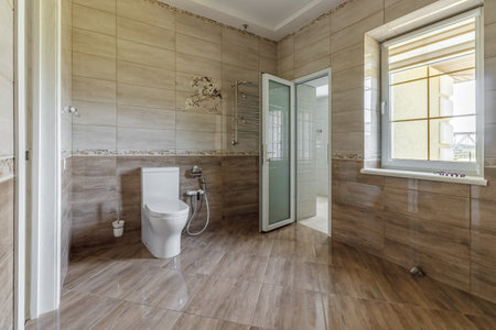 Interior of an unfinished bathroom with freshly laid ceramic tiles.の写真素材