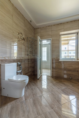 Interior of an unfinished bathroom with freshly laid ceramic tiles.の写真素材