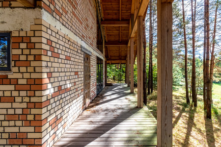 A house under construction in a pine forest on a sunny autumn day.の写真素材