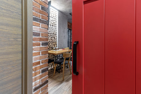 Apartment interior with sliding red door and clay red brick wall decoration.の写真素材