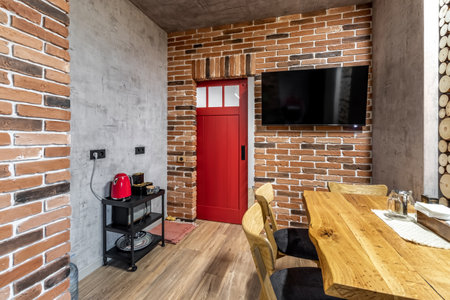 Apartment interior with sliding red door and clay red brick wall decoration.の写真素材