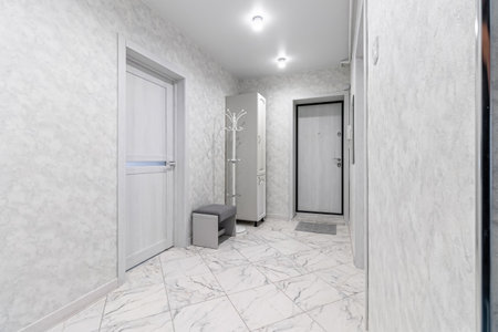 Empty gray hallway in contemporary living apartment without furniture and with closed doors.の写真素材