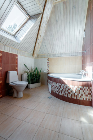 A spacious bathroom with heated floors, a separate bathroom, shower, double shell and windows.