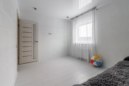 Space of empty white children's room with sofa and colorful inflatable ball.の写真素材