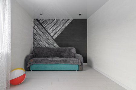 Space of empty white children's room with sofa and colorful inflatable ball.の写真素材