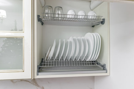 pure white cup with plate, standing in white cupboard.の写真素材