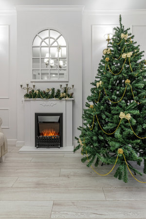 Nordic, cozy living room interior with a Christmas tree, white tones, coffee table, and sofa.の写真素材