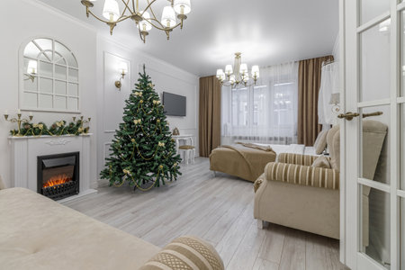 Nordic, cozy living room interior with a Christmas tree, white tones, coffee table, and sofa.の写真素材