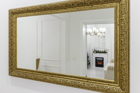 Hall in modern apartment with big mirror and passage to the rooms.