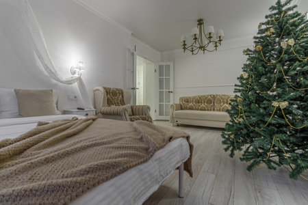 Nordic, cozy living room interior with a Christmas tree, white tones, coffee table, and sofa.の写真素材