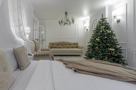 Nordic, cozy living room interior with a Christmas tree, white tones, coffee table, and sofa.の写真素材