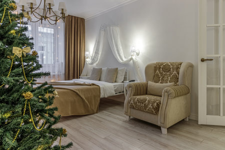 Nordic, cozy living room interior with a Christmas tree, white tones, coffee table, and sofa.の写真素材
